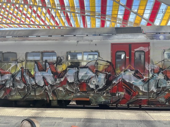 SNCB Break EMU covered in grime and graffiti at Liege Guillemins. Side view. Graffiti covers windows. 