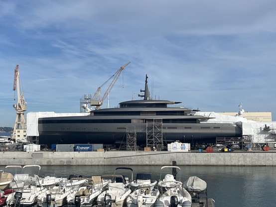 A massive ugly superyacht under repair at La Ciotat (Monaco Marine). It’s grey and black and threatening looking. 