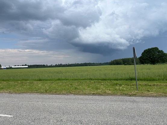 An open expanse of fields and a road in front 