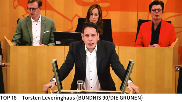 Torsten Leveringhus am Redepult im Hessischen Landtag. Dahinter die Präsidentin und zwei Abgordnete im Sitzungsdienst.