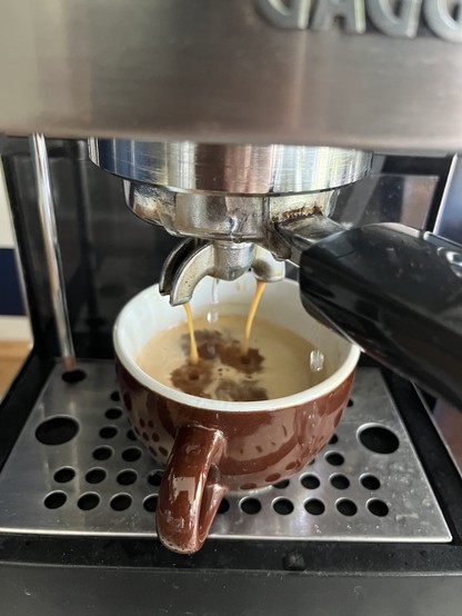 Espresso being prepared. You can see water dripping in the middle between the two espresso drips 