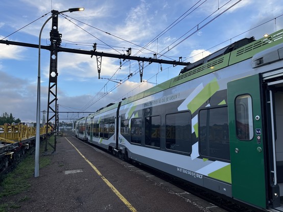 Green and grey Régiolis train at Nuits sous Ravières. 